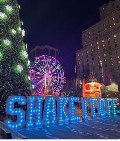 there is a large sign that says shaker town in front of a christmas tree