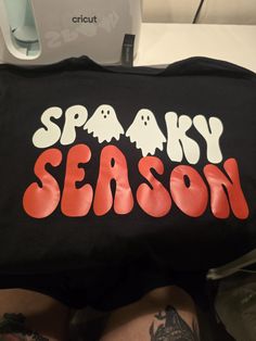 Made to order spooky season shirt! This is fully customizable, please dm with the color shirt, size and the color vinyl you would like! I can also make this with glitter vinyl! Ex) L black tshirt with pink vinyl Spooky Black T-shirt With Screen Print, Black T-shirt With Heat Transfer Vinyl Band Merch, Black Fun T-shirt With Custom Print, Fun Black T-shirt With Custom Print, Black Spooky Letter Print T-shirt, Cute Shirt Designs Vinyl, Pink Vinyl, Cute Shirt Designs, Vinyl Shirts