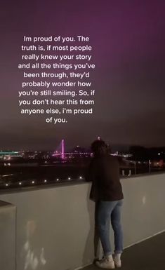 a person standing on top of a building next to a purple sky with the words, i'm proud of you