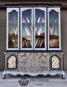 an ornate china cabinet with mirrored doors and windows