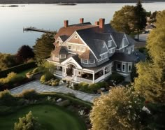 an aerial view of a large house near the water