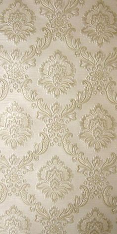 a white wallpaper with an ornate design on it