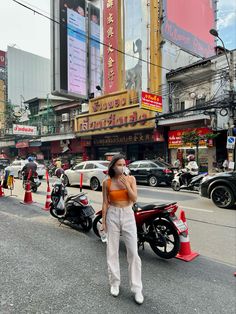 a woman standing on the street talking on her cell phone