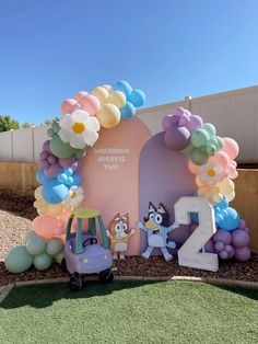 the balloon arch is decorated with balloons and flowers