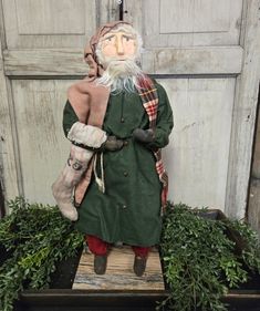 a statue of an old man wearing a green coat and hat