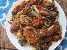 a white plate topped with meat and vegetables on top of a blue and white table cloth