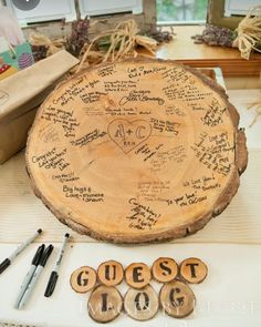 a table topped with lots of writing on wooden slices