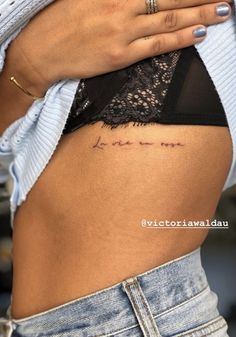 a woman's stomach with the word love written in cursive writing on it