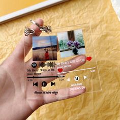 a person holding up a piece of clear plastic with pictures attached to the side of it