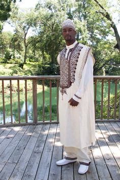 MALIK means “King” in Swahili a language spoken in Kenya, Tanzania, and other countries of East Africa. You will feel like a king when wearing this outfit hence the name Malik. FOR MAN: This male 4 piece assemble has agbada (gown)~ dashiki (shirt)~ trousers and kuffi hat. Embroidery adorns the agbada~ dashiki~ hem of trousers and hat. Fabric is Guinea brocade. Made in Ghana. All sales final. Order now. Royal Reference, Bridal Dresses African, Angie Stone, Long Robes, Hat Fabric, African Wedding Attire, Dashiki Shirt