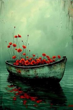 a boat filled with red flowers floating on top of water