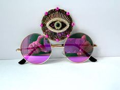 💓Third eye statement sunglasses by Alexis Exclusive !  💓This quirky pair of Third Eye Sunglasses are the perfect unusual accessory if you love something different. 💓The three lenses are gold metal and they have mirrored pink ombre lenses. In the centre lens they have a decorative bronze and gold eye plus gold pink scattered around the edges. 💓Great for festivals, carnivals, holidays, or everyday wear if that's your thing 😉 💓UV protection. 💓Exclusive design made by myself, you won't see an Third Eye Sunglasses, Statement Sunglasses, Gold Eyes, Pink Ombre, Third Eye, Eyewear Sunglasses, Exclusive Designs, Concept Design, Sunglasses Accessories