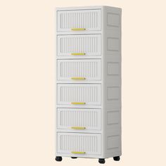 a tall white cabinet with four drawers on wheels and yellow labels on the bottom drawer