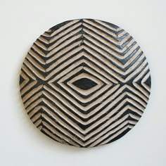 a black and white circular object on a wall