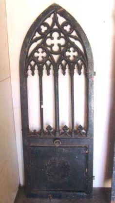 an old iron door in the corner of a room