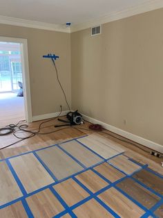 an empty room with hard wood flooring being installed