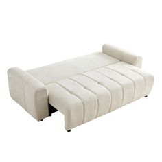 a white couch sitting on top of a wooden floor