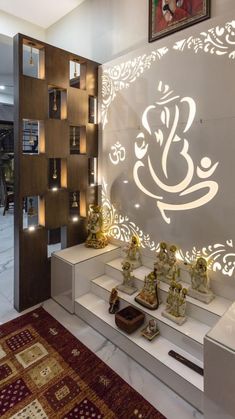 the interior of a store with decorative items on display in front of an illuminated wall