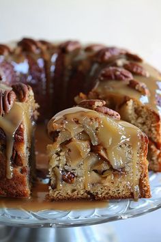 a bundt cake with pecans and caramel drizzle on top