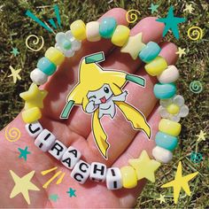 a hand holding a yellow and blue bracelet with the word cirach on it