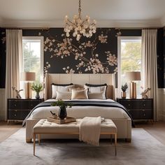 a bedroom with a large floral wallpaper on the wall and a chandelier hanging from the ceiling