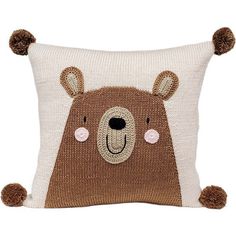 a brown bear pillow with pom - poms on the front and back of it