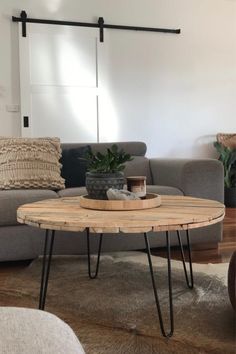 a living room with a gray couch and wooden table