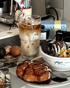 there are many desserts and drinks on the counter top, including one with ice cream