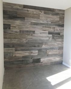 an empty room with wood planks on the wall