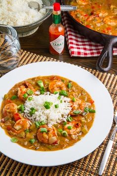 a white plate topped with shrimp and rice