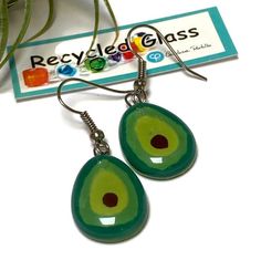 Green Avocado small dangle earrings. Fun Design! These earrings are made of recycled fused glass. The glass is cut, painted and fired in a kiln. When the glass fuses each bead bubbles in its own way becoming an intriguing creation. All the beads are handmade in small batches, please allow slight variations. That is what makes this technique so interesting and beautiful.The glass bead is about 0.65'' white and 0.8'' long. The earrings (hook to bottom are approx 1.6 longSterling silver fish hook wires.All the earrings come with rubber back stoppers. The diameter of the bead is approx .65 inches.The earring is about 1.35 inches long from the hook to the end of the glass.Please like my facebook pagewww.facebook.com/recycledglassjewelry**This is not sea glass, or dichroic glass. We work with fl Small Dangle Earrings, Bubble Earrings, Glass Drop Earrings, Dichroic Glass, Wine Charms, Stud Earrings Set, Everyday Earrings, Recycled Glass, Glass Jewelry