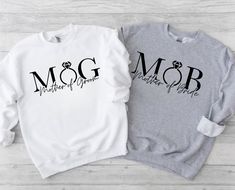 two sweatshirts with the words mcg and mother of pearl on them sitting next to each other