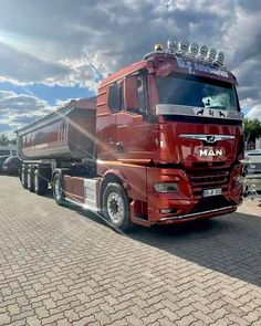 a red semi truck parked in a parking lot