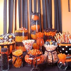 an assortment of candy and candies on display in front of black drapes