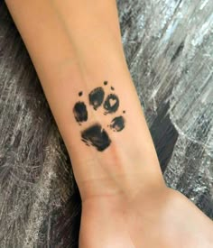 a person with a paw print on their wrist and foot in the middle of it