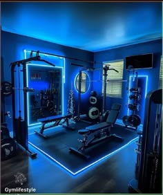 a home gym with blue lighting and equipment