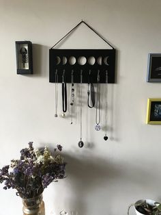 a vase filled with flowers sitting on top of a table next to a wall mounted clock