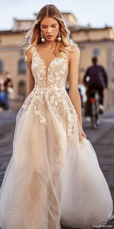 a woman in a wedding dress walking down the street