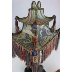 a decorative lamp with tassels and beads on it