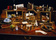 a table topped with lots of assorted items and mirrors on top of it's sides