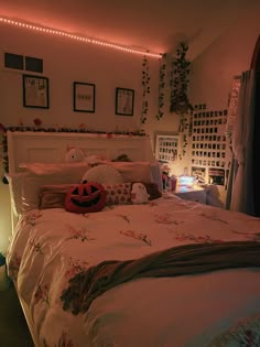 there is a bed that has been decorated with flowers and lights on the headboard