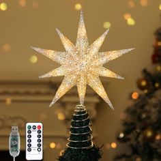 a lighted christmas tree topper next to a remote control