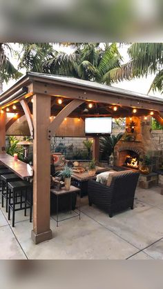 an outdoor patio covered with furniture and lights