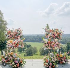 an outdoor ceremony setup with flowers and greenery