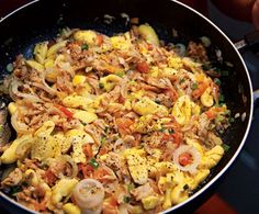 a skillet filled with food sitting on top of a stove