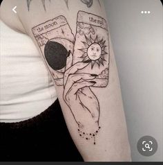 a woman's arm with tattoos on it and an image of the sun in her pocket