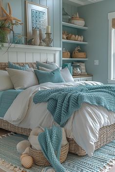 a bedroom with blue walls and white bedding, sea shells on the rugs