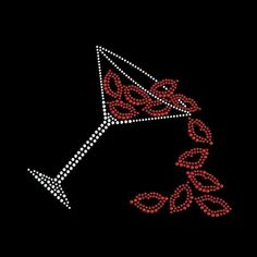 a red and white dotted martini glass on a black background