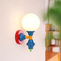 a blue and yellow wall light with a white ball on the back of it's arm