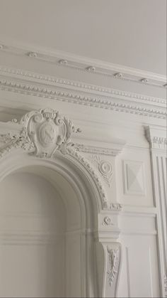 an ornate white fireplace surround in a room